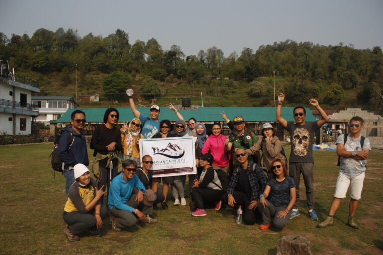 group of trekkers holding mountain eye treks banner